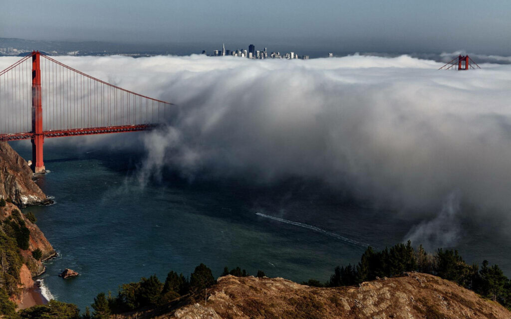 Mystical Encounter: San Francisco Cityscape Embracing Enigmatic Fog-Drenched Golden Gate Bridge Wallpaper