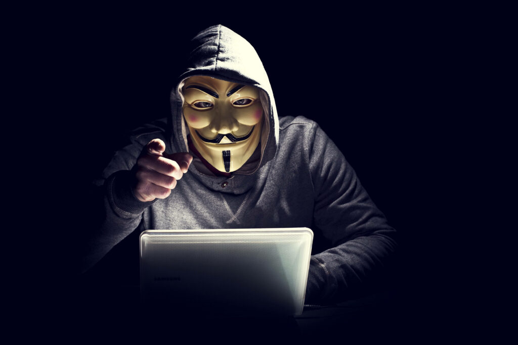 Iconic Hacker with Laptop: The Trademark Avatar of Anonymous Group Unleashed in 5k HD Wallpaper