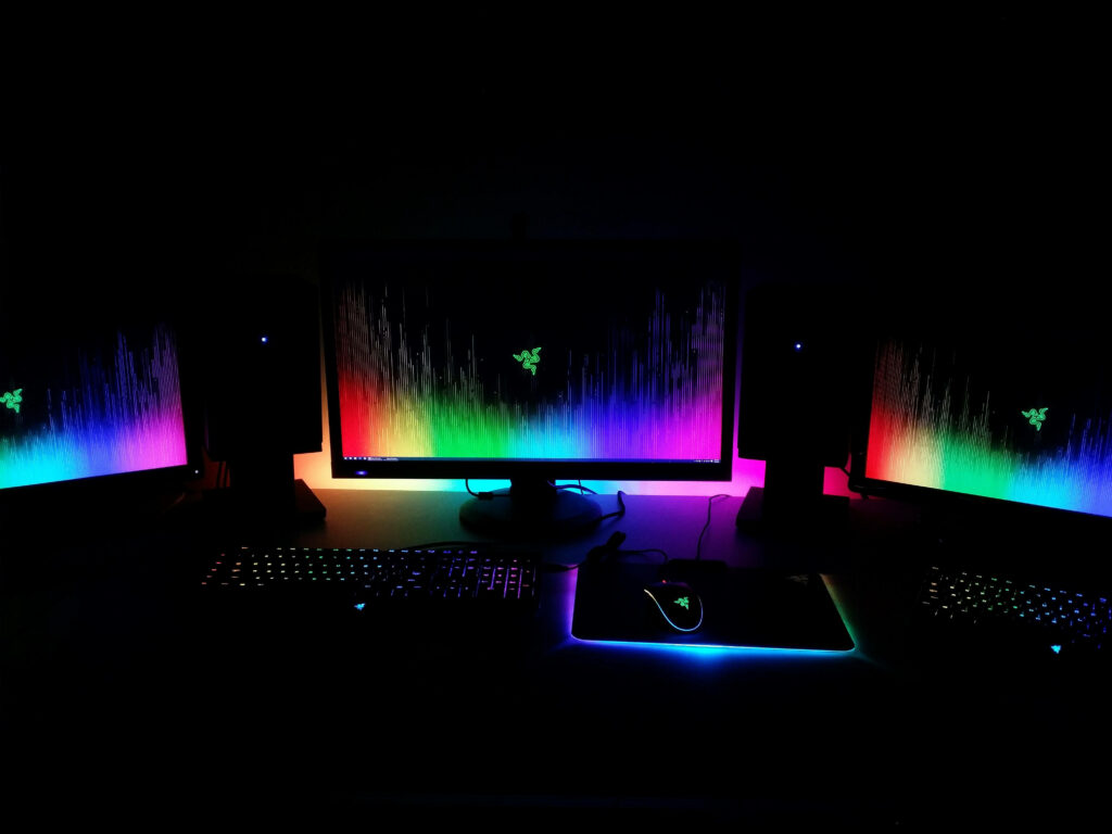 The Enigmatic Tri-Screen Gaming Realm: Ethereal Rainbow Desktops Illuminate an Enigmatic Gaming Sanctuary Wallpaper