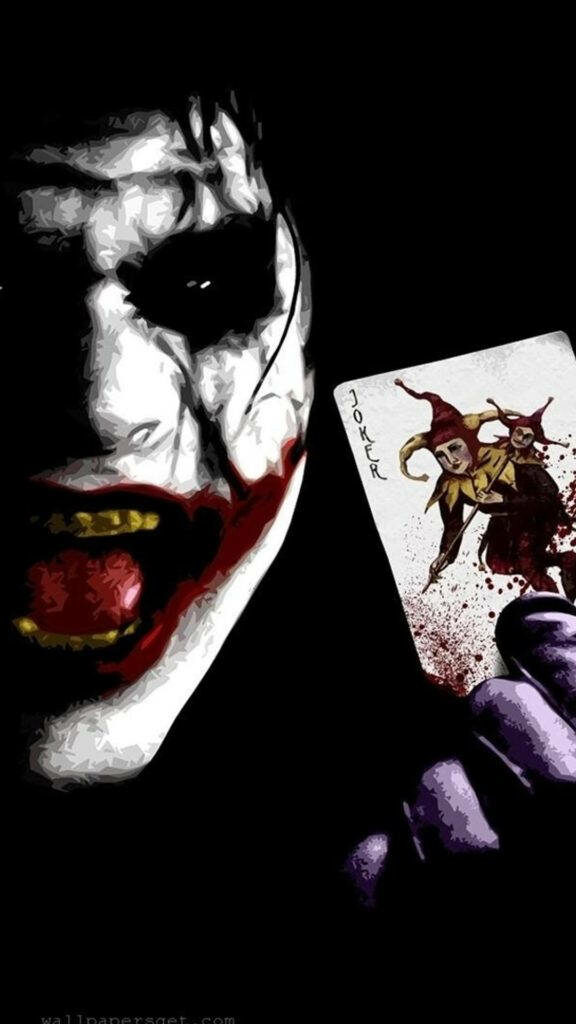 The Sinister Grin: A Eerie Portrait of Heath Ledger as the Joker, Embracing the Shadows with a Mysterious Joker Card Wallpaper