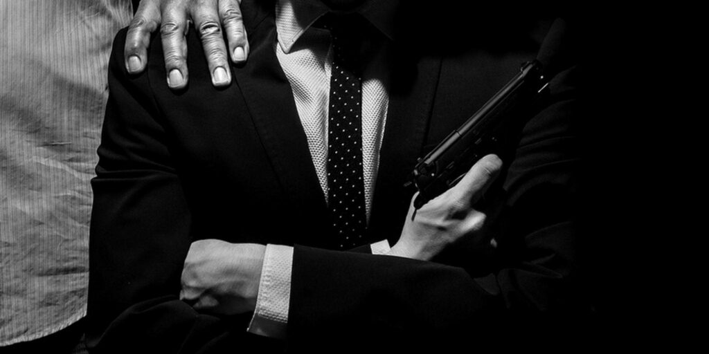 The Enigmatic Boss: A Noir Portrait of an Italian Mafioso, Armed and Confident Wallpaper