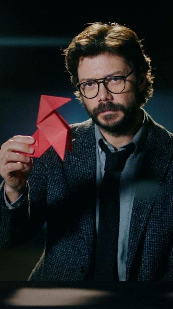 The enigmatic Professor unveils a crimson origami masterpiece amidst a captivating darkness Wallpaper