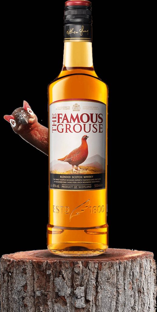 The Famous Grouse whisky bottle on tree stump with curious red grouse warm golden tones wallpaper
