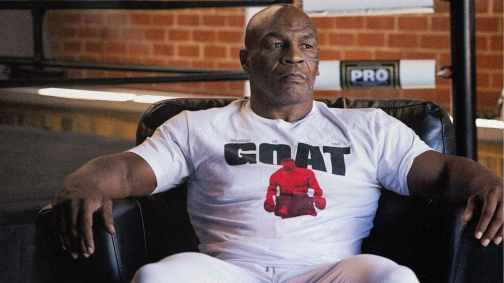 Gazing into Greatness: Mike Tyson, The Undisputed GOAT, Contemplates on The Couch Wallpaper