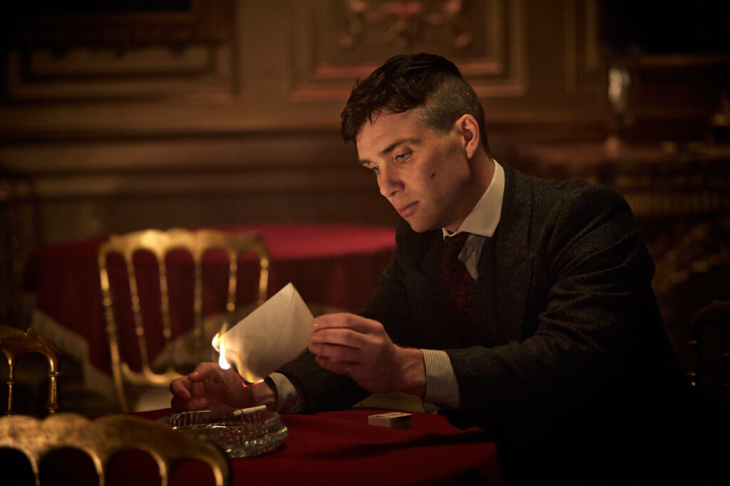 Burning the Past: A Captivating 8k Wallpaper of Tommy Shelby from Peaky Blinders
