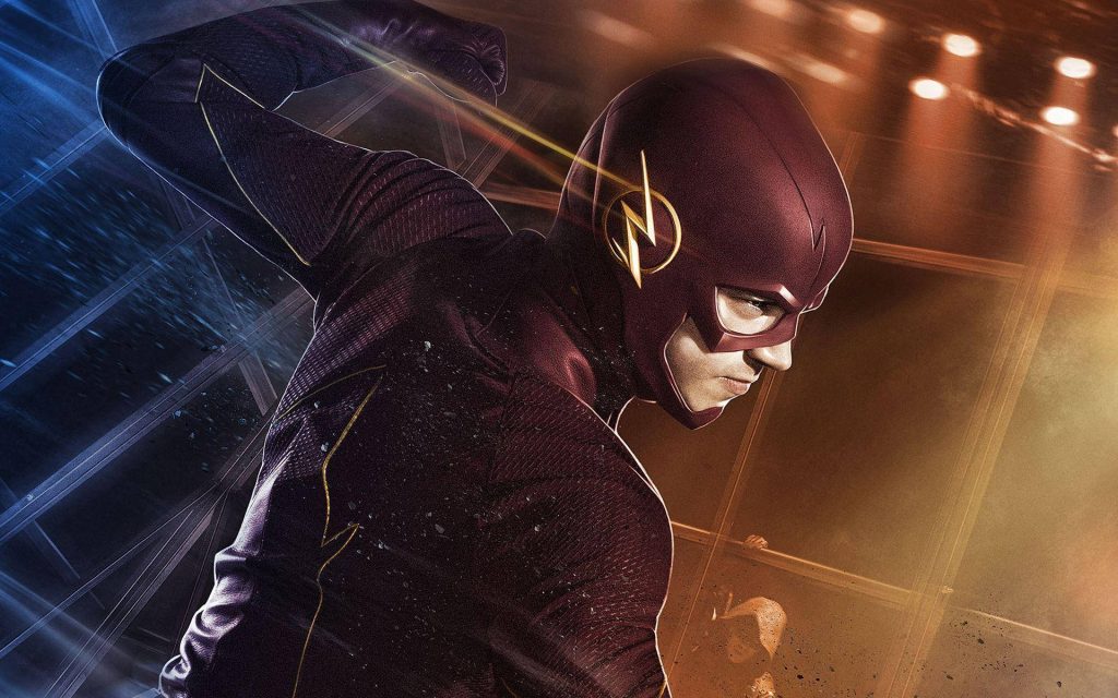 Grant Gustin as The Flash in dynamic pose with vibrant red suit and blue amber lighting wallpaper