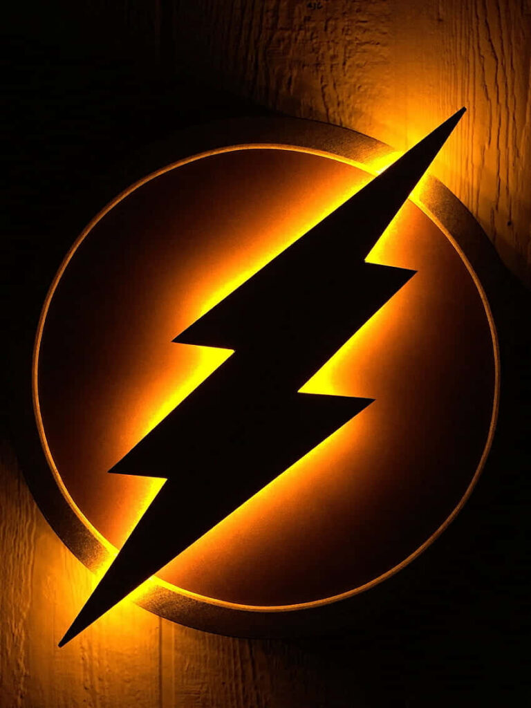 The Flash logo with black lightning bolt and golden glow on textured wall wallpaper background