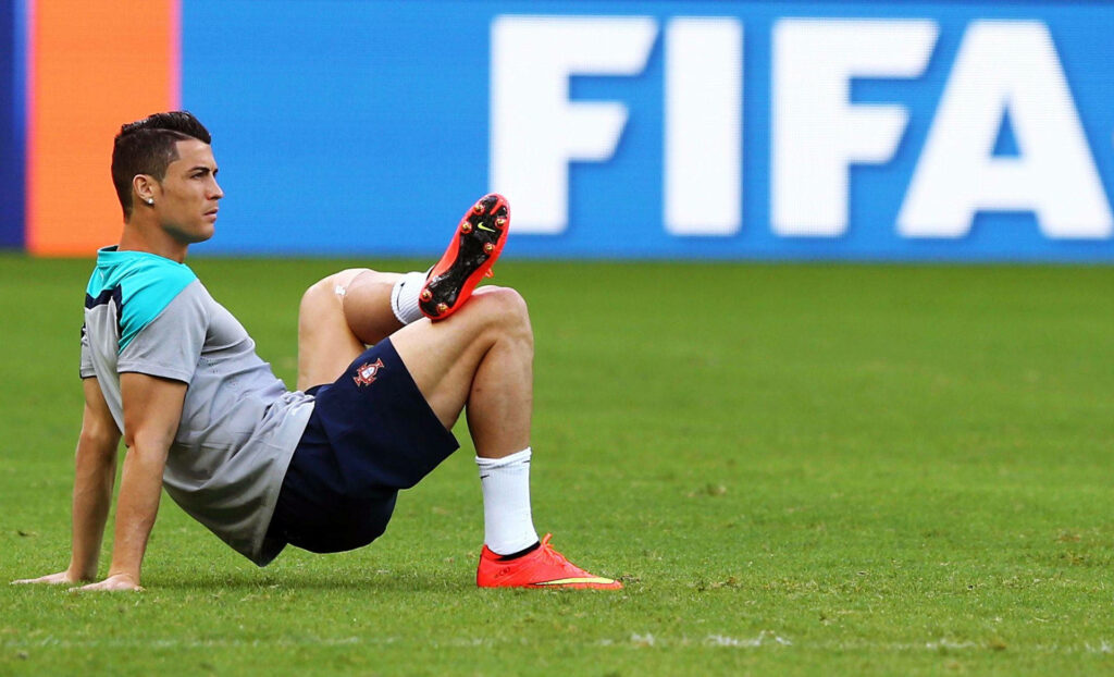 Gravity-Defying Cr7 Showcasing Skills on Football Field Wallpaper