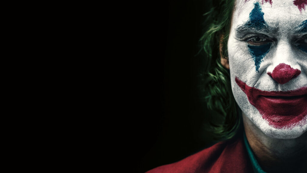 The Enigmatic Face: A Mesmerizing 4k Wallpaper Showcasing Joker/Arthur Fleck, the Troubled DC Character, Against a Captivating Black Backdrop - Remarkable 4k Background Shot