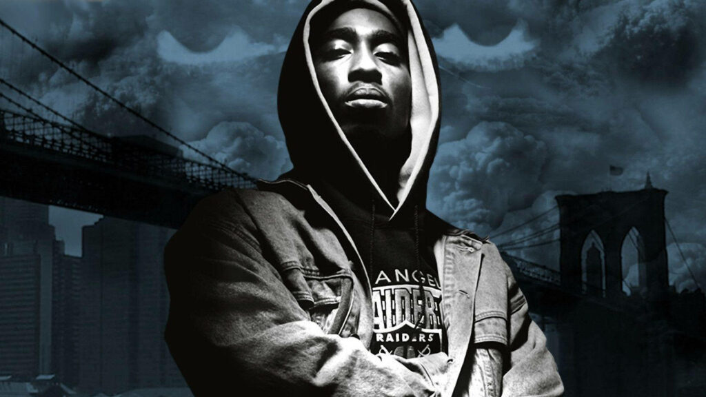 The Iconic Tupac Shakur: Gray Scale Wallpaper with a Bridge Backdrop