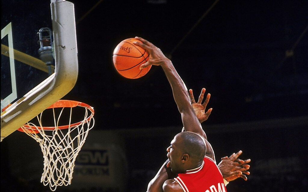 Michael Jordan soaring for a slam dunk in Chicago Bulls jersey basketball wallpaper background