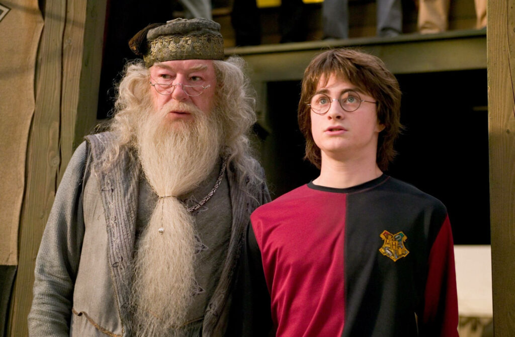 An Enthralling Portrait Unveils Albis Dumbledore with Harry Potter in a Solemn Moment Wallpaper