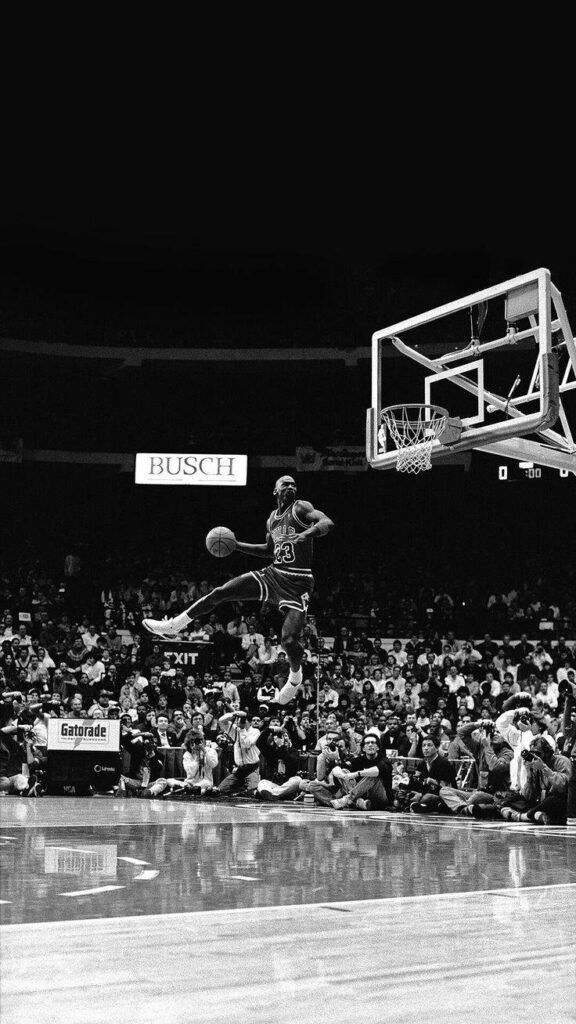 Dunk Master: Michael Jordan Soars in Breathtaking 1988 Slam Dunk Exhibition, Thrilling Massive Audience Wallpaper