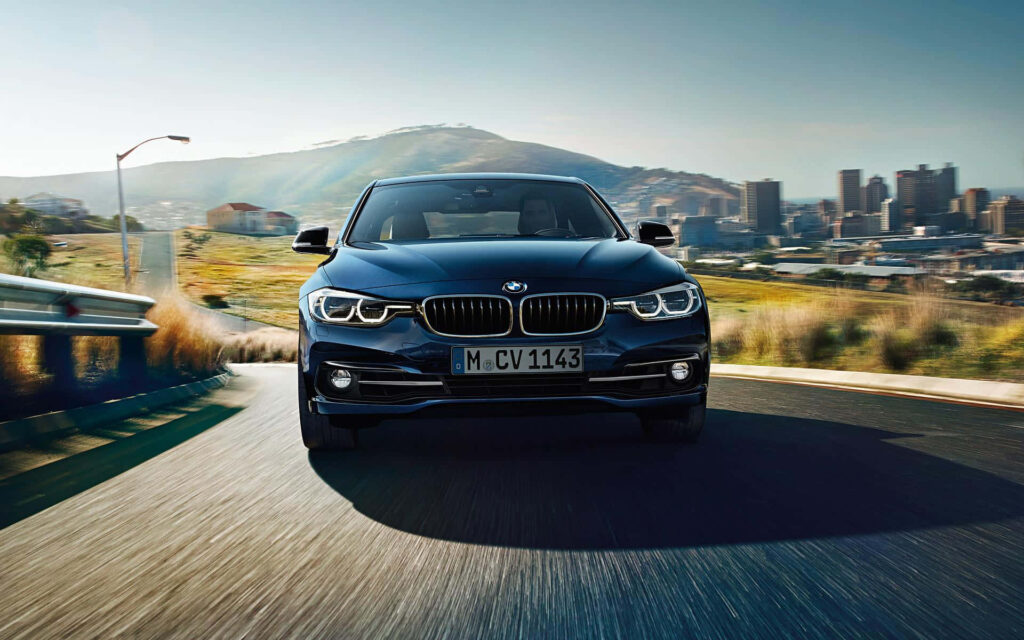 Dark Blue BMW M Series Car in a City Background Wallpaper