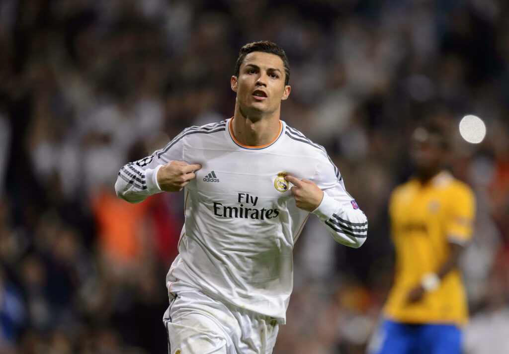Dazzling Cr7: Ronaldo's Electrifying Run Amidst Adoring Fans in All White Attire Wallpaper