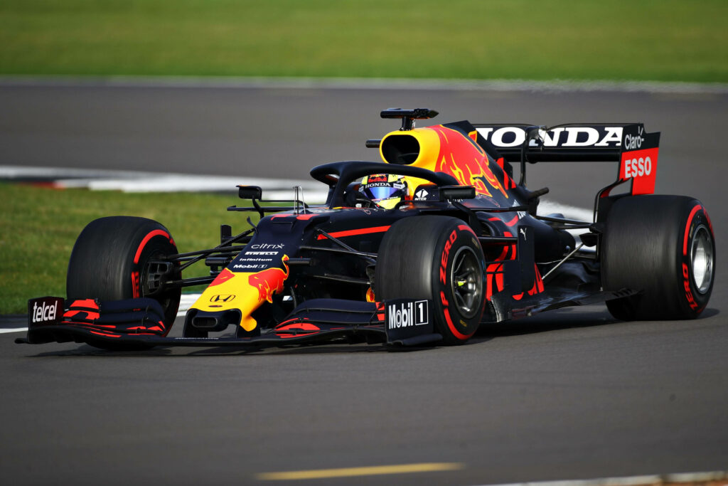 Sergio Perez Masterfully Navigates His F1 Machine on the Track: A Captivating Snapshot Wallpaper
