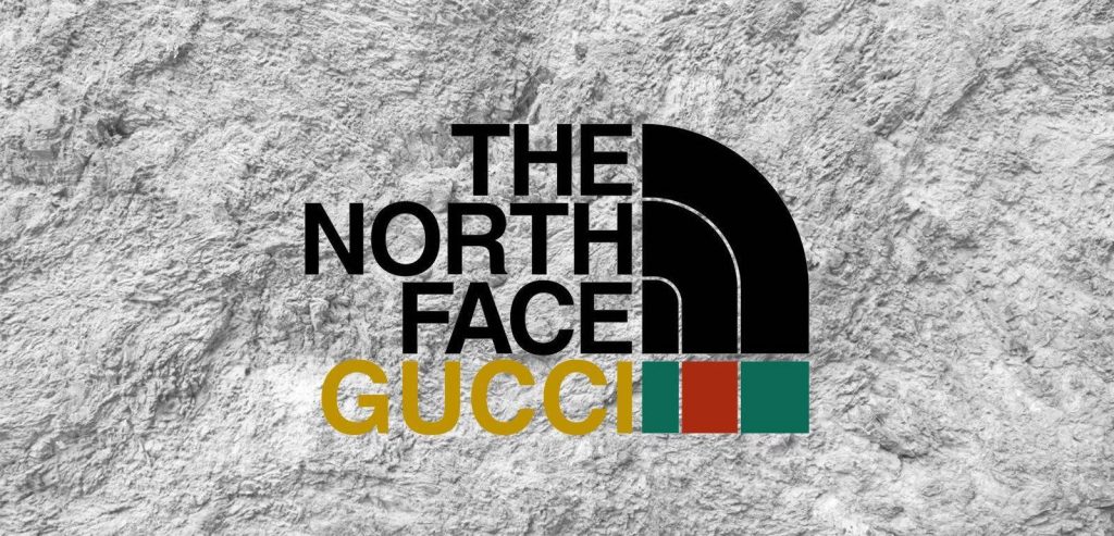 The North Face x Gucci logo wallpaper on textured grey stone background luxury outdoor style