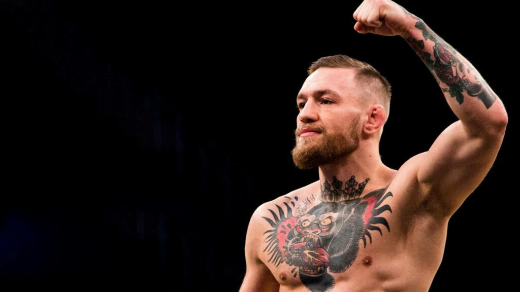 The Maverick's Might: Conor McGregor's Iconic Fist Raise in a Cool Wallpaper