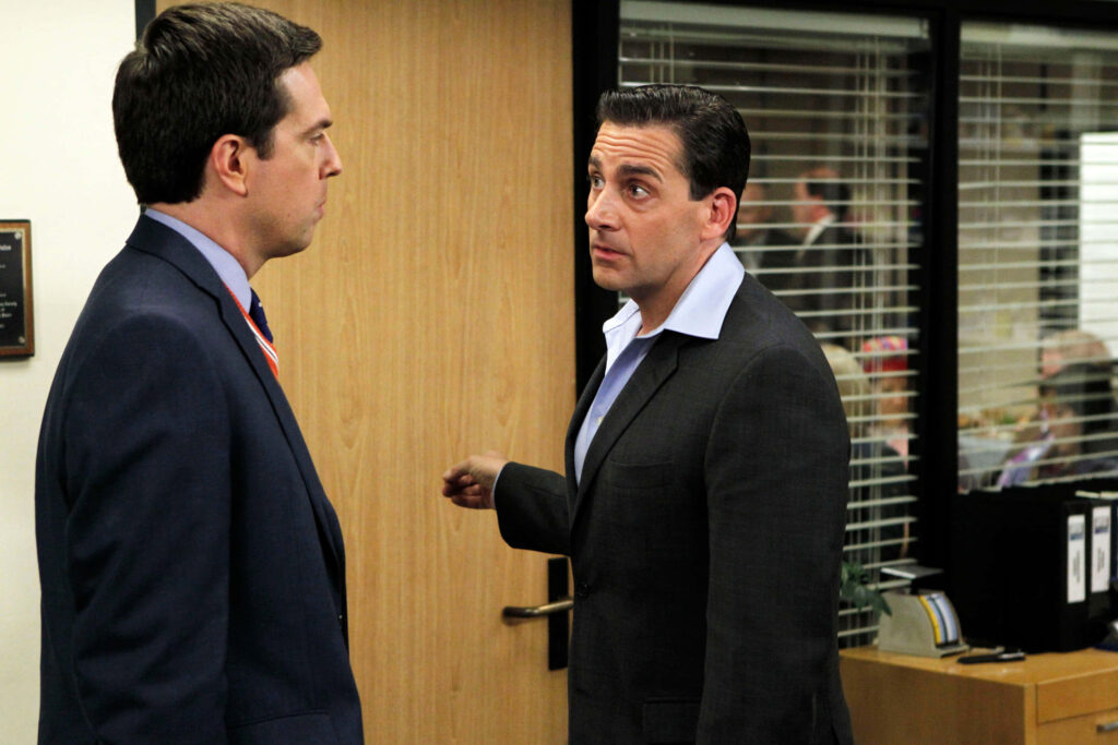 Andy Bernard and Michael Scott from The Office in a candid office scene with neutral tones wallpaper