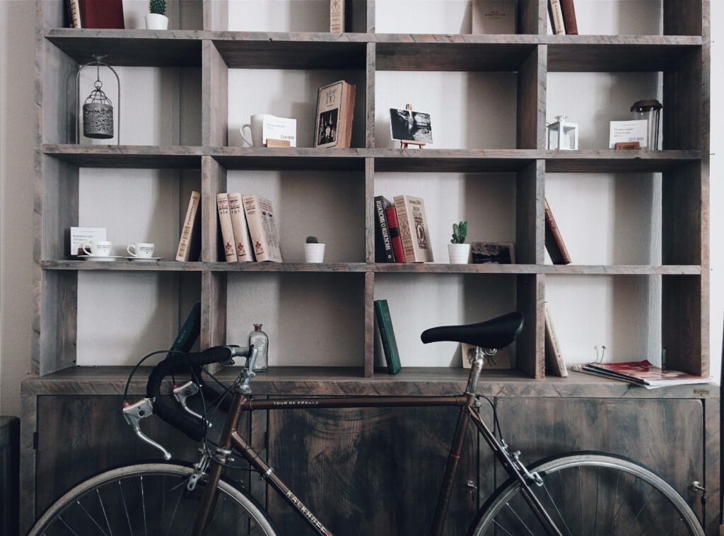 Vintage Bicycle Display Shelf: A Stylish Blend of Shabby Chic and Book Themed Delight Wallpaper
