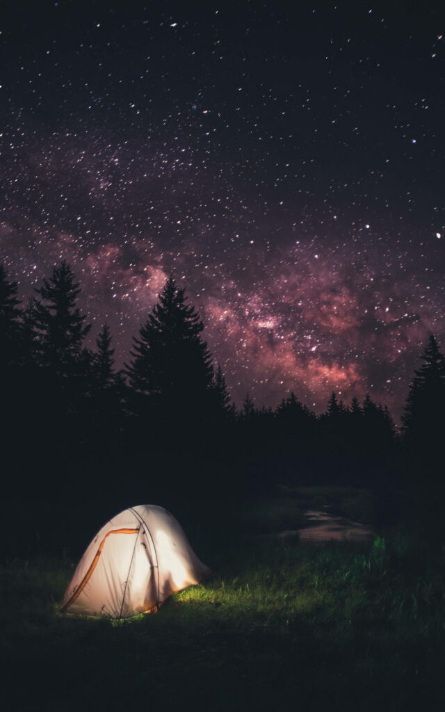 Starry Night Camping under Glowing Stars Mobile Wallpaper - A High-Resolution Nature Image with a Tent Pitched under the Sparkling Night Sky