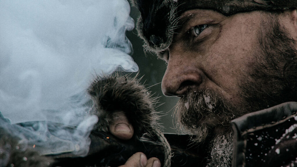 Close-up of The Revenant main character with frosty breath and rugged wilderness details wallpaper
