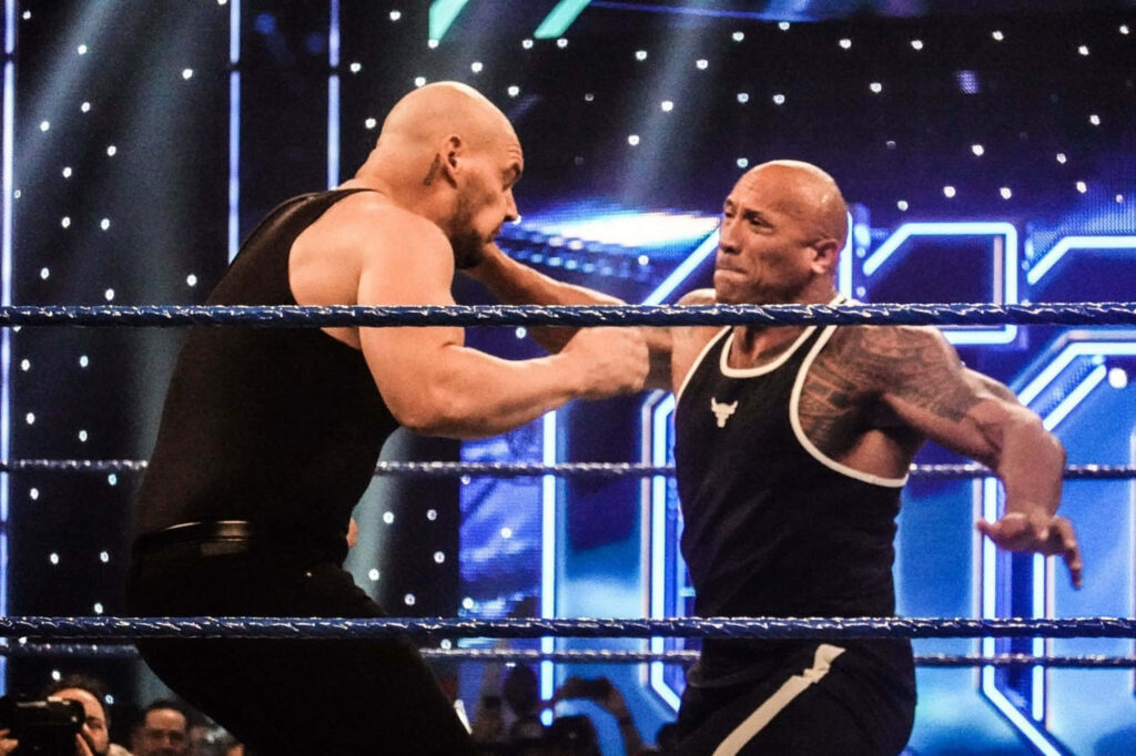 The Rock and Baron Corbin intense WWE wrestling match dynamic wallpaper background energy