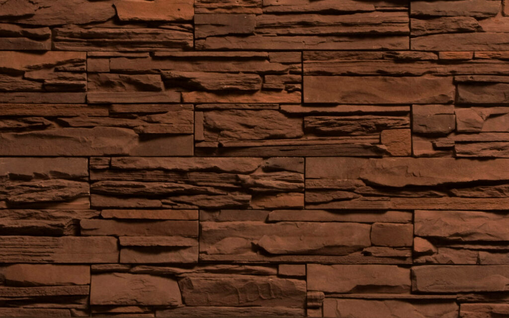 Close-up of stacked brown stone cladding with layered texture rustic minimalist desktop background Wallpaper