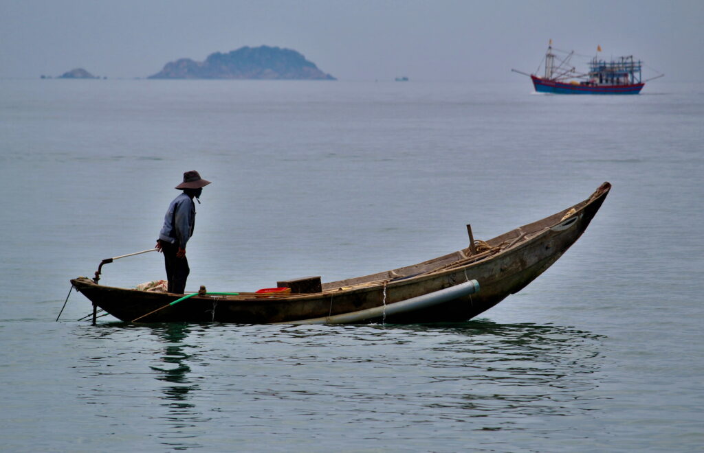 Serene Waters: A Tranquil Journey on a Fishing Boat Wallpaper
