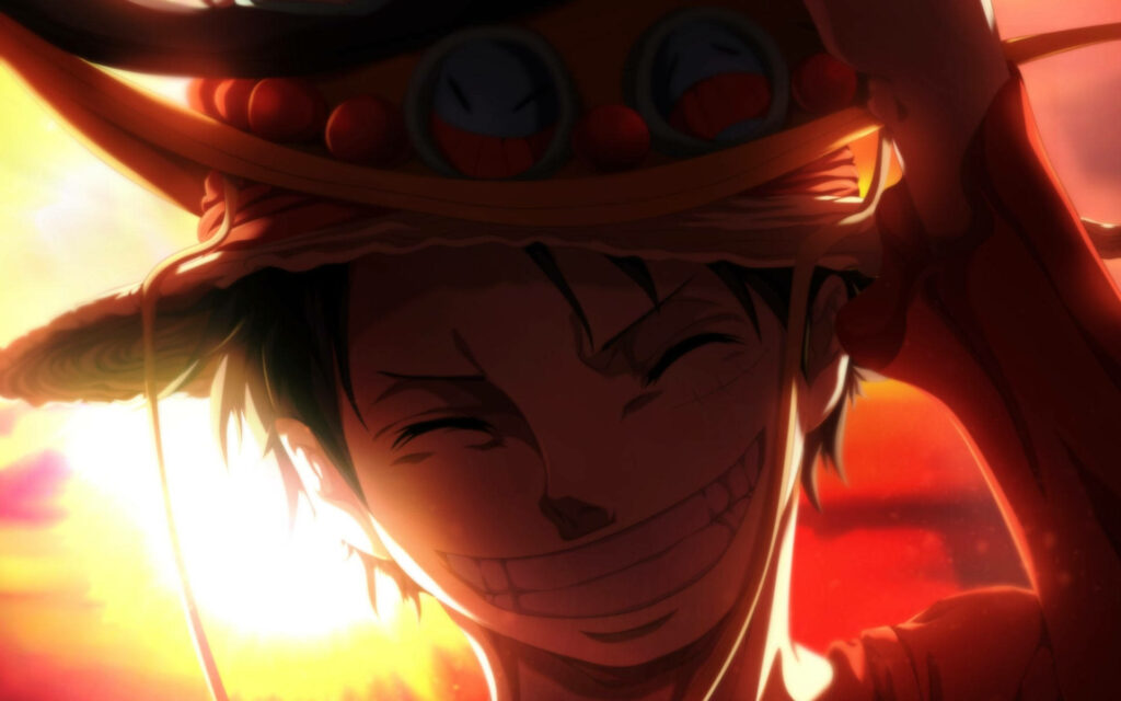 The Smiling Straw Hat: Luffy's Radiant Joy Amidst a Golden Sunset Wallpaper