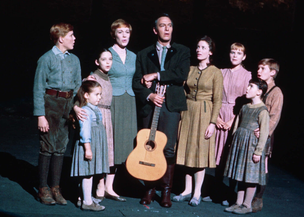 The Sound Of Music cast singing together with guitar in iconic musical performance scene wallpaper