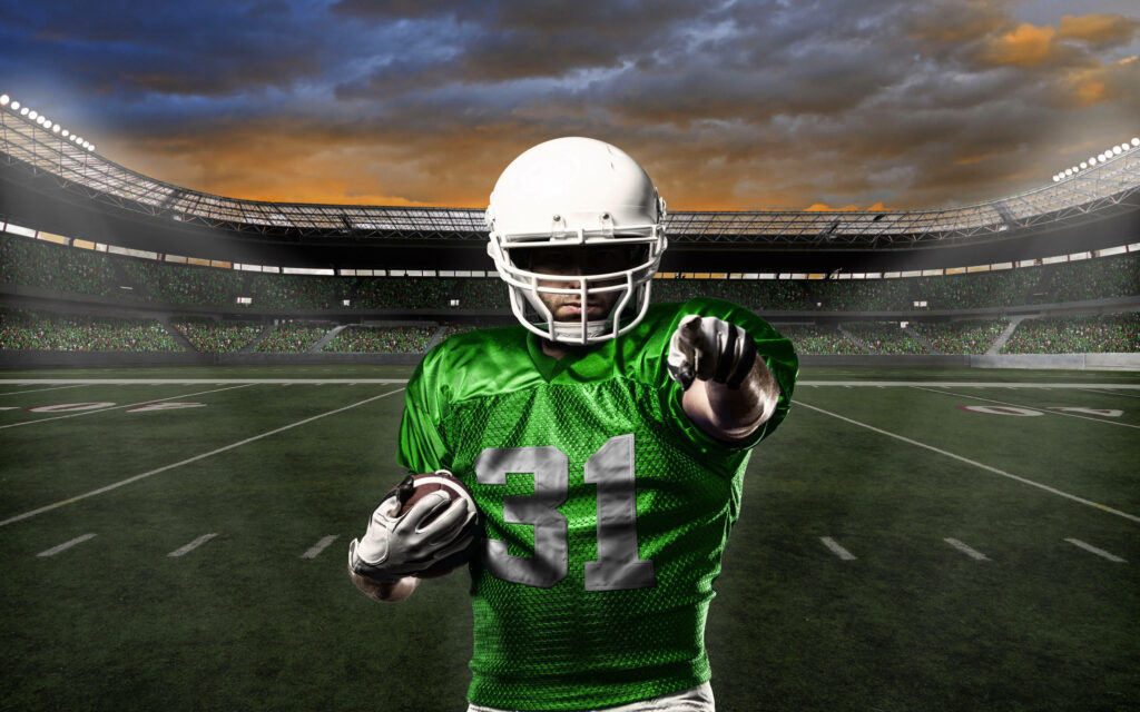 The Green Guardian: A Captivating Shot of a Dynamic Football Player in the Stadium Wallpaper in QHD 2K 2560x1600 Resolution