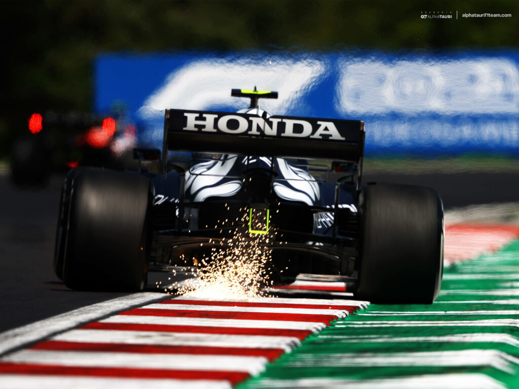 The Powerhouse of Speed: Alphatauri F1 Roars Ahead with Striking Honda Branding! Wallpaper
