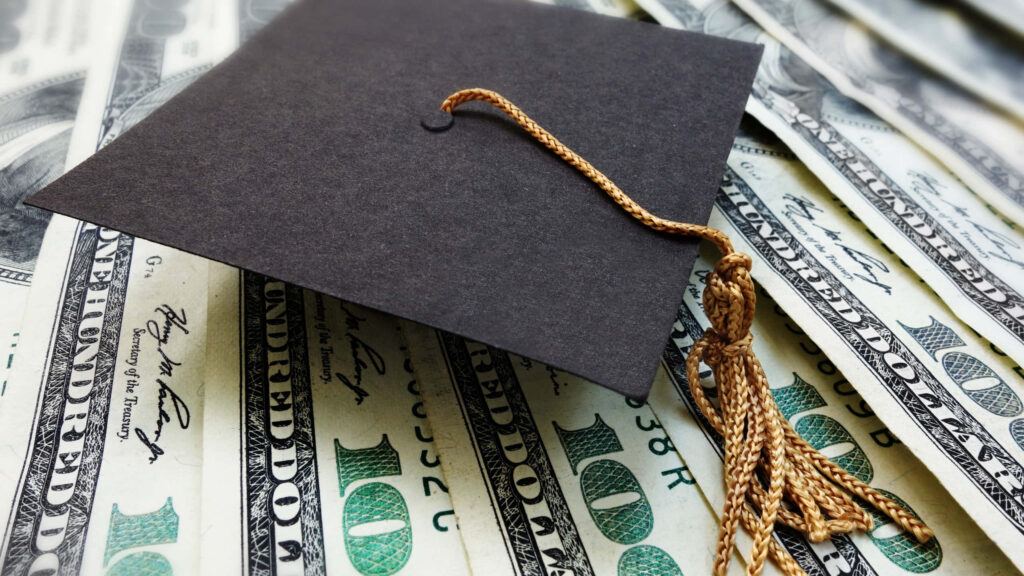 Symbolic Success: Celebrating Graduation Amid Financial Opportunity Wallpaper