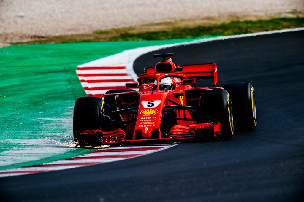 Blazing Speed: Ferrari F1 2018 Ignites a Fiery Trail with Sparkling Right Wheels on the Race Track Wallpaper