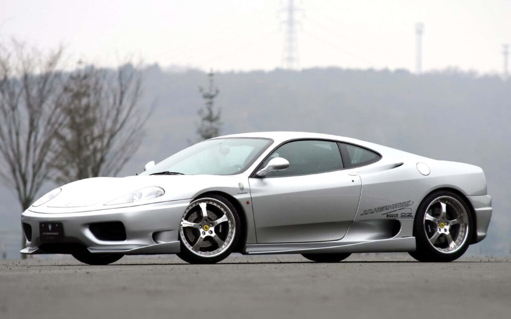 Exquisite and Speedy: The Timeless Red Ferrari 360 Modena Dazzles as it Conquers the Open Road Wallpaper