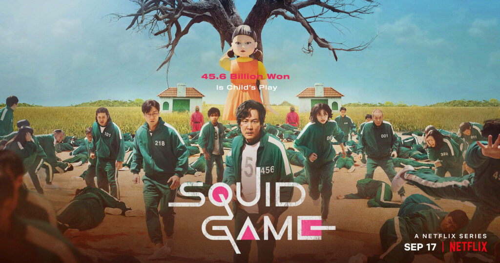 Netflix Squid Game key art poster featuring contestants racing past fallen players and giant doll Wallpaper
