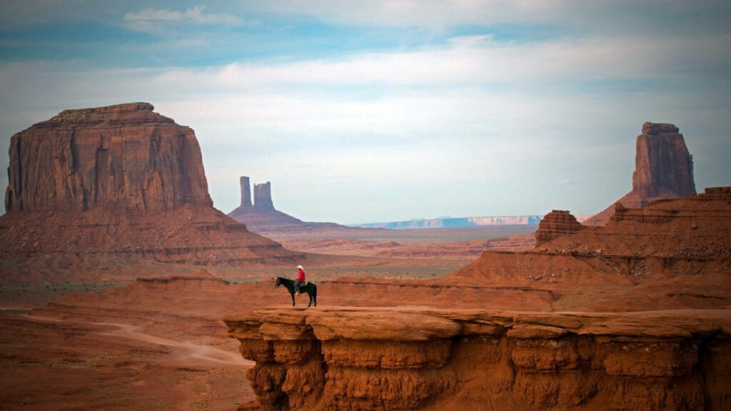 Legends of the Wild West: Horseback Rodeo at Sunset Wallpaper