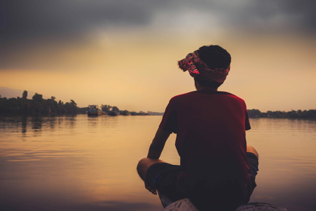 The Lonely Young Boy Gazing into the Abyss on a Serene Wallpaper Background
