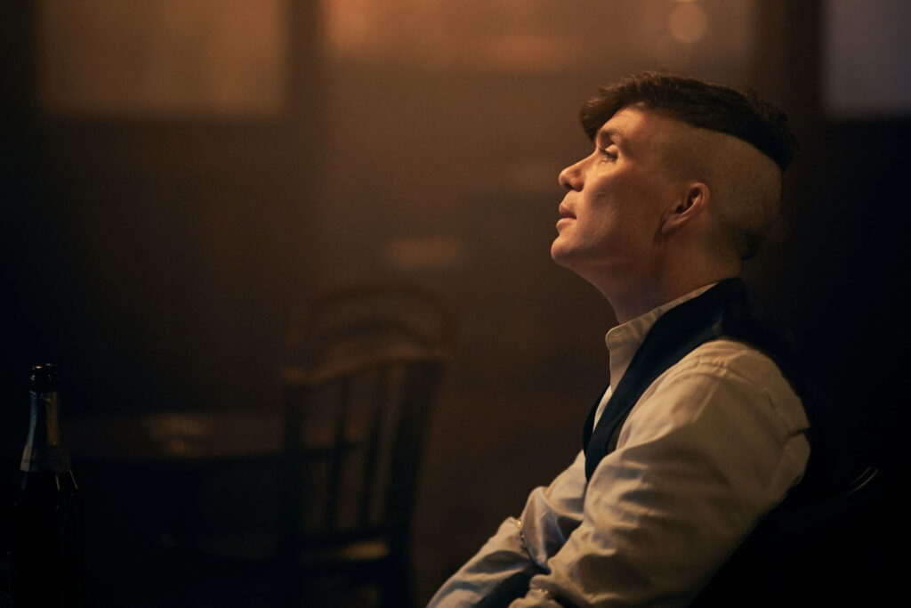 Charisma of Thomas Shelby: A Stunning Peaky Blinders Wallpaper Background with Cillian Murphy