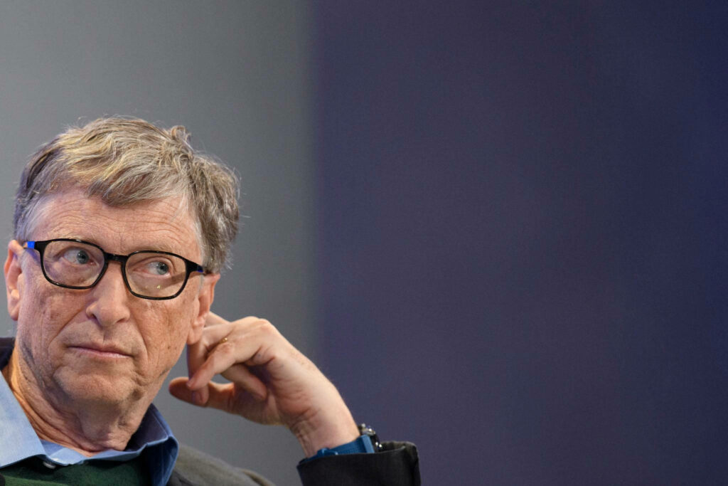 Candid portrait of Bill Gates thoughtful expression blurred background wallpaper image