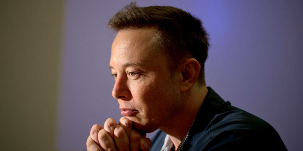 Thoughtful Elon Musk Wallpaper: Visionary CEO Interview Background