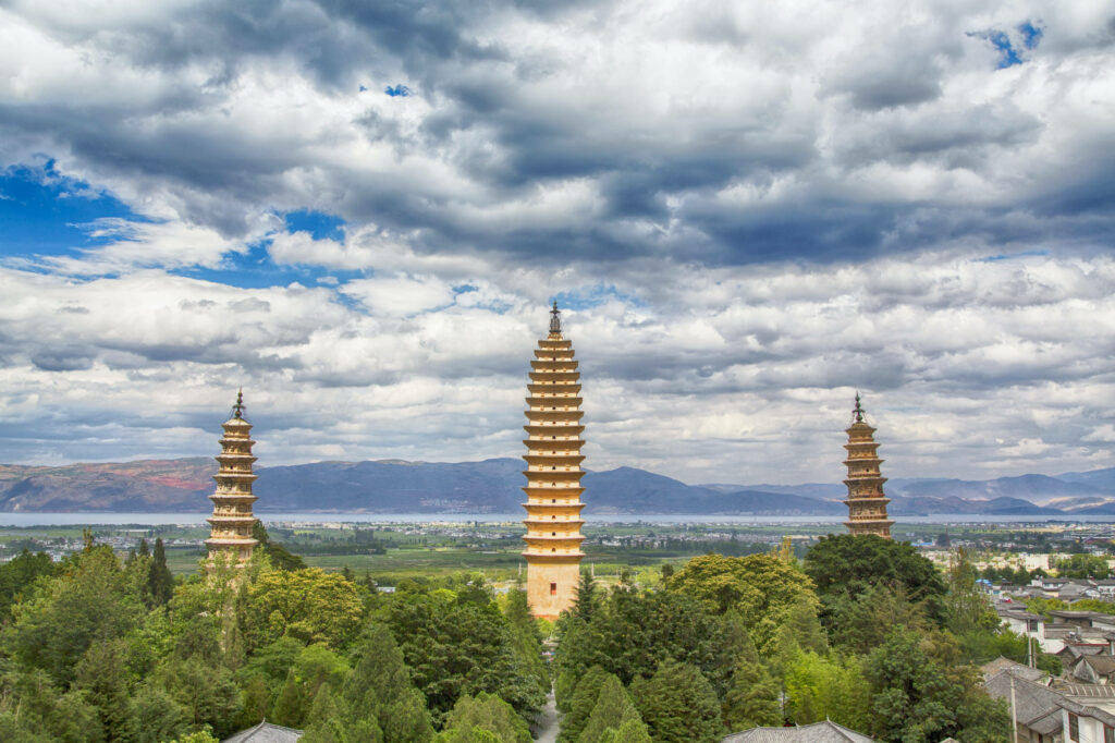 Three Pagodas Wallpaper: Lush Greenery & Dramatic Mountain Views