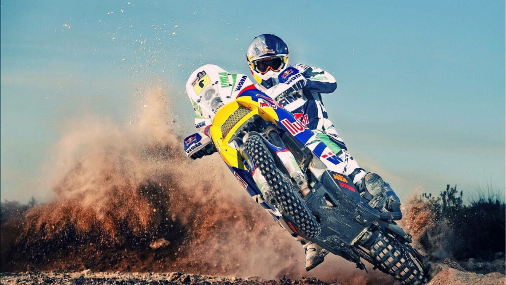 Thrilling Dirt Bike Ride Wallpaper: Man Conquering Dusty Terrain