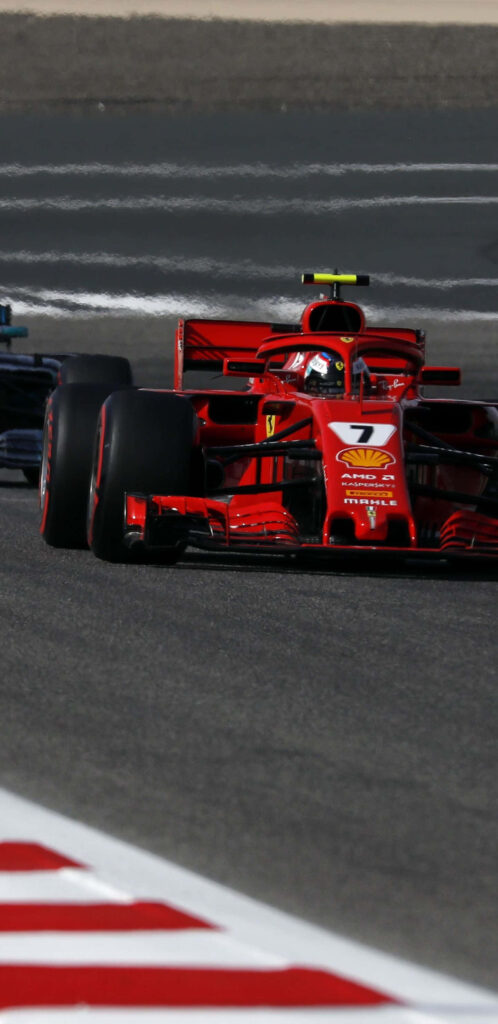 Ferrari SF71H: Revving to Victory in the 2018 FIA Formula One World Championship - A Captivating Snapshot Set Against a Striking Background Wallpaper