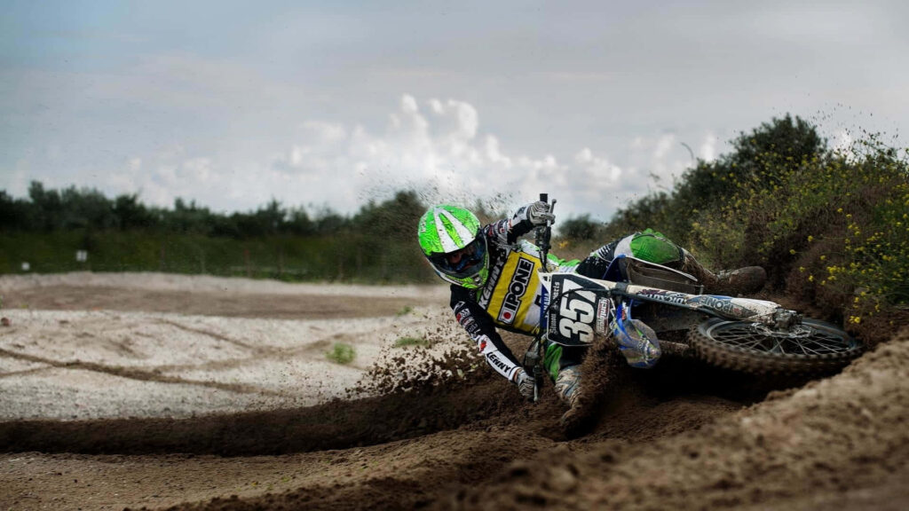 Thrilling Honda Dirt Bike Rider Wallpaper: Neon Green Action Splash