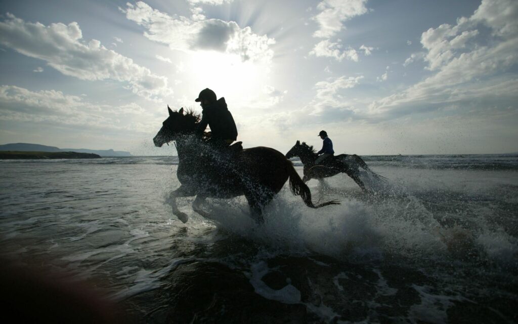 Thrilling Horseback Riders Galloping Through Water - 1920x1200 Wallpaper