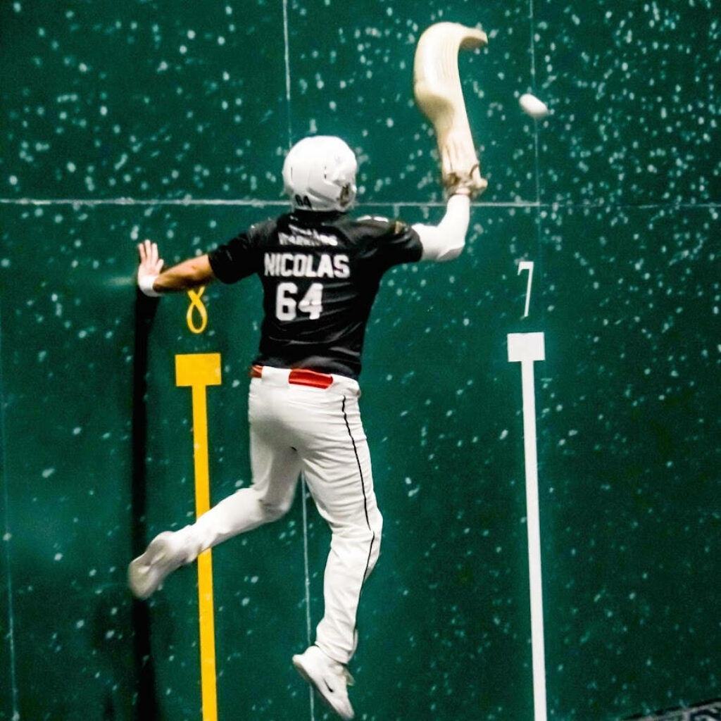 Agile Jai Alai Player Nicolas in Action - Thrilling Wallpaper Background
