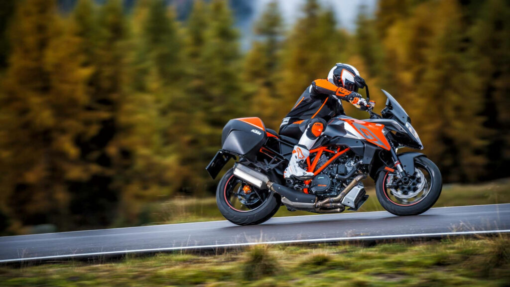 Dynamic KTM Motorcycle Ride 4K Wallpaper with Autumn Trees