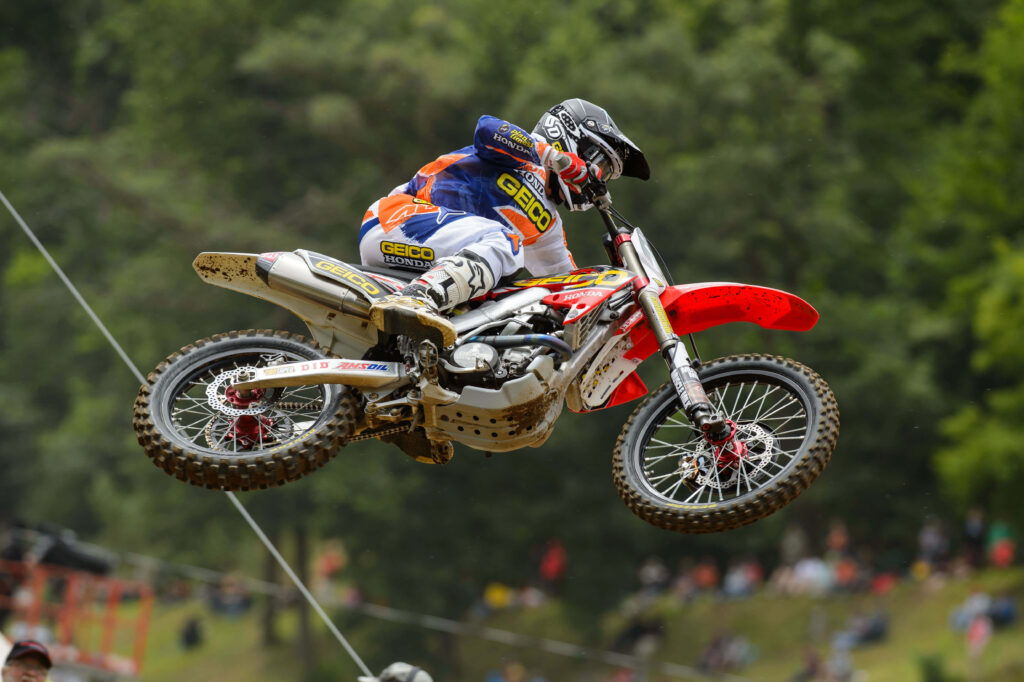 Thrilling Motocross Rider Wallpaper - Action-Packed Forest Scene